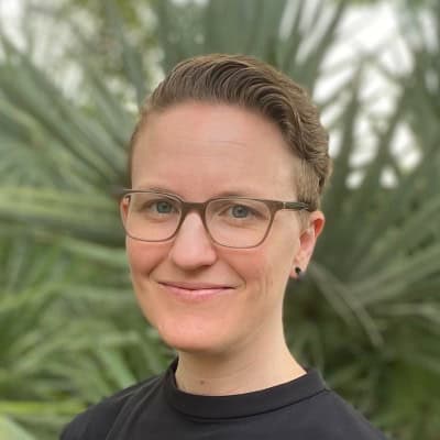 a person smiles outside